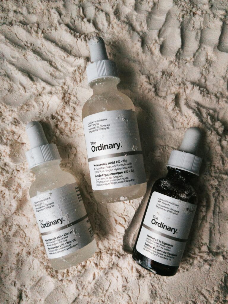 Đánh Giá Mỹ Phẩm Luneria: Tọa Độ Vàng Mua Skincare Hàn Quốc Chính Hãng Three dropper bottles of The Ordinary serums displayed on a powdery surface.