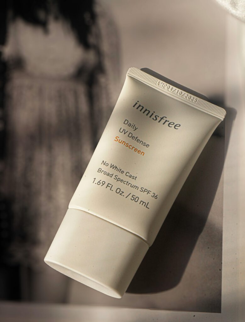 Close-up of Innisfree sunscreen in natural light, showcasing packaging details.